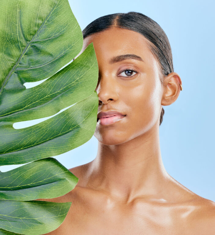 Skincare, plant and portrait of a woman on a blue background for skincare, wellness and beauty glow.